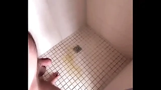 Guy pissing anent shower